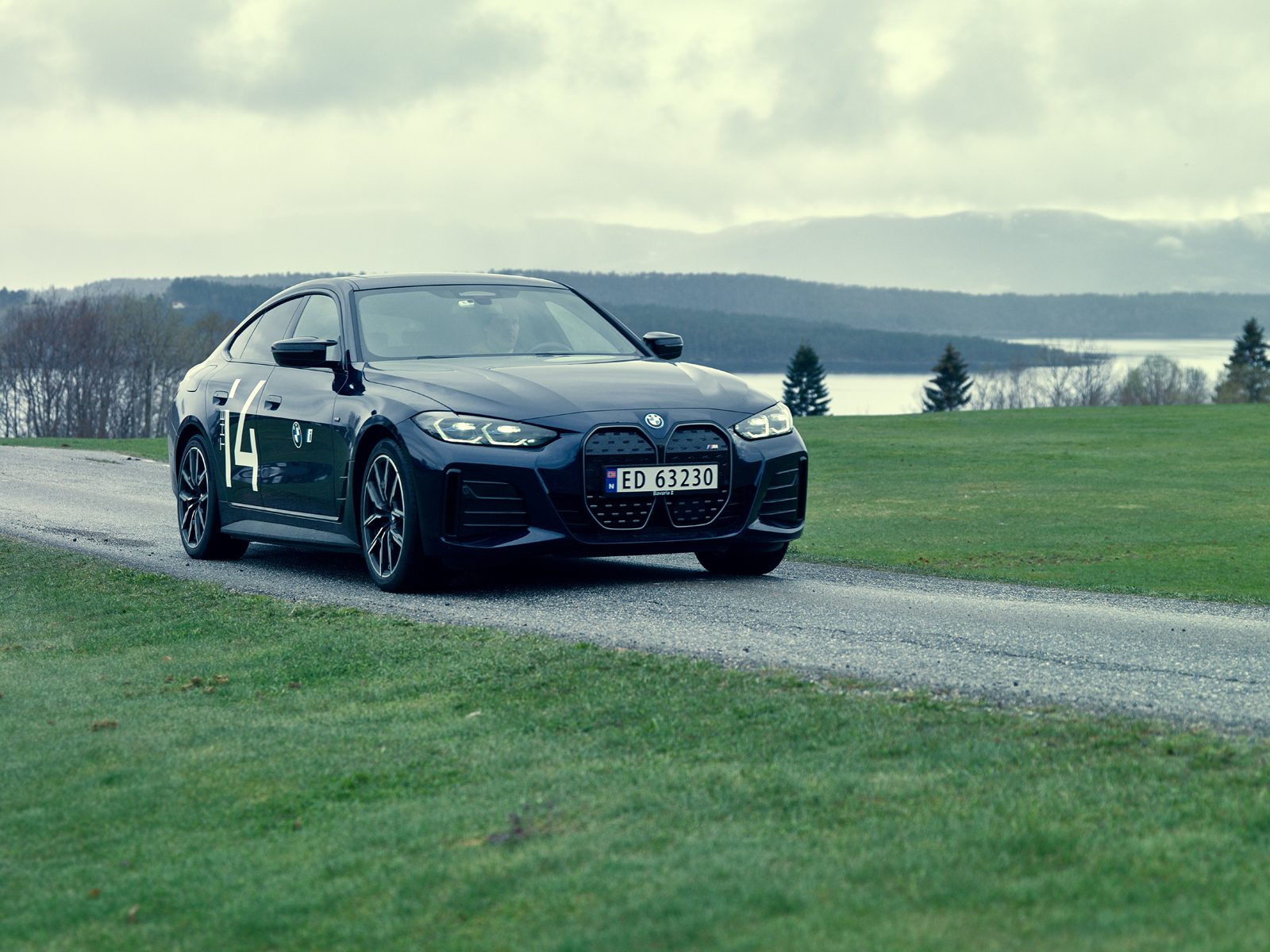 Vehicle registration plate, Automotive tire, Sky, Wheel, Car, Grille, Hood, Cloud