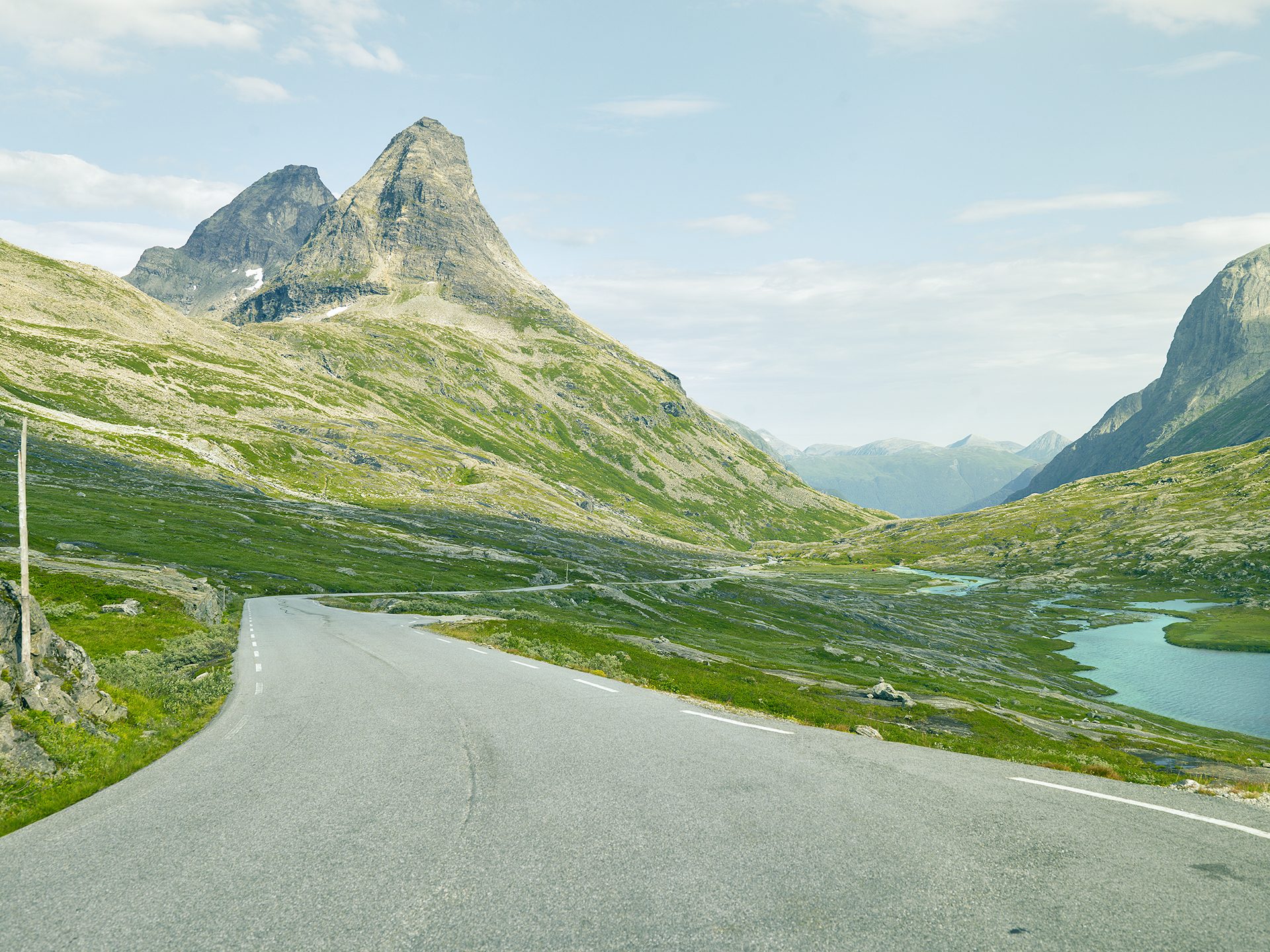 Natural landscape, Road surface, Cloud, Sky, Mountain, Water, Ecoregion, Slope, Asphalt, Watercourse