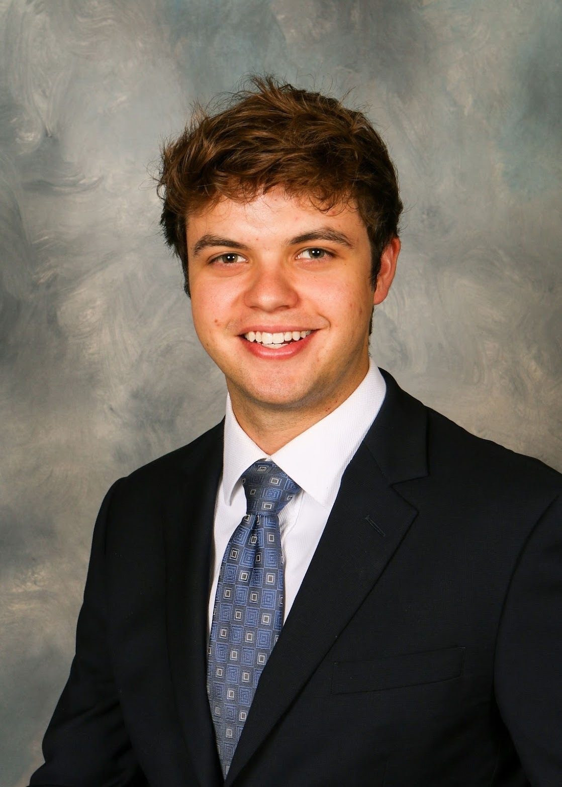 Formal wear, Smile, Chin, Eyebrow, Forehead, Collar, Happiness, Hairstyle, Necktie, Jaw