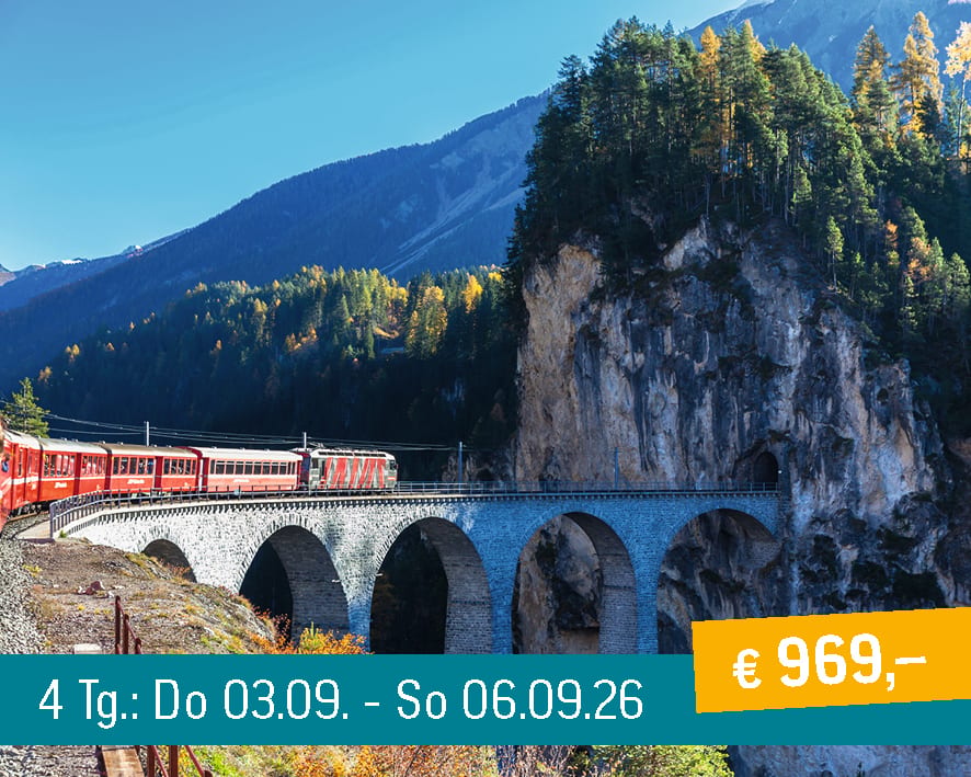 A scenic view of a red train crossing a majestic stone viaduct amidst a rugged autumn mountain landscape.