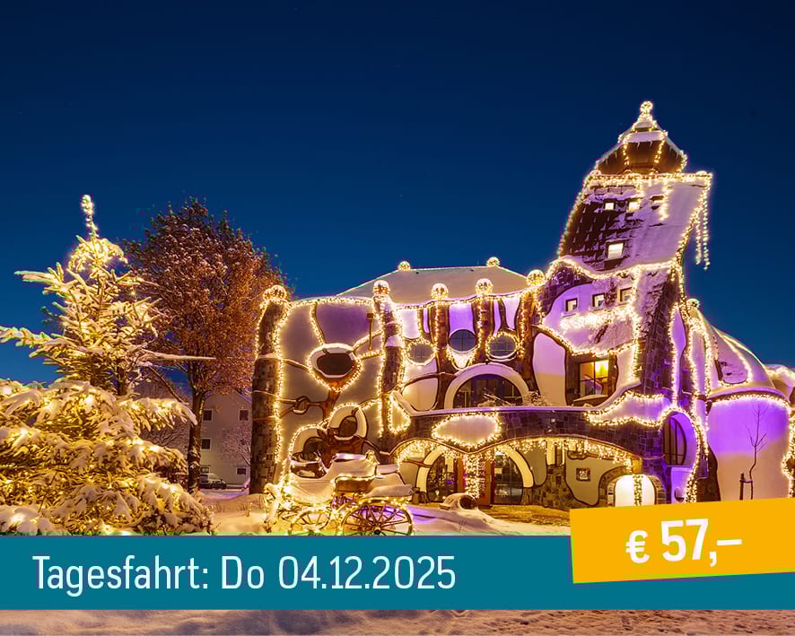 Snow-covered, illuminated whimsical building with Christmas lights and a carriage at dusk.