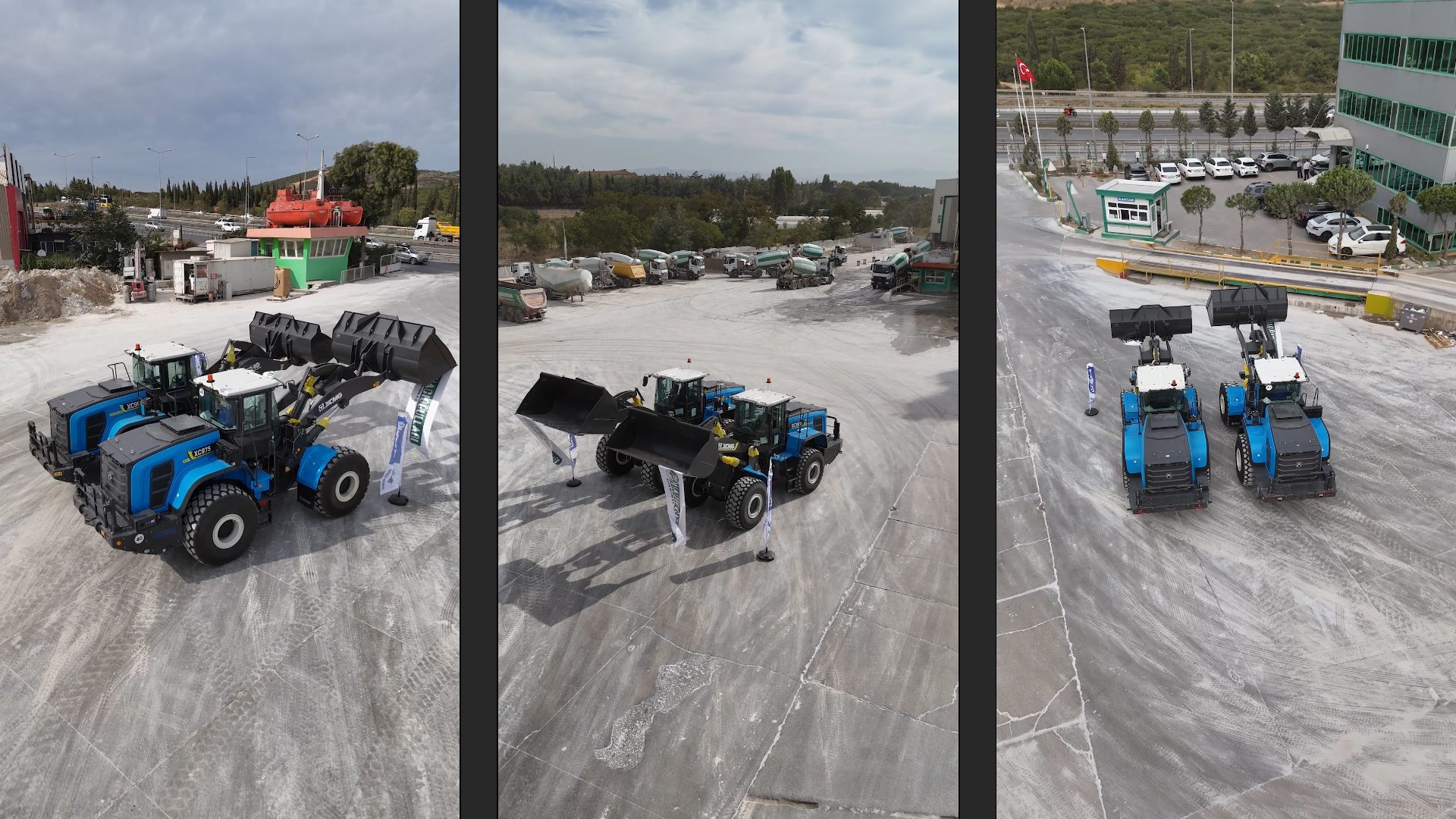 Two blue XCMG XC975 wheel loaders parked in an industrial yard.