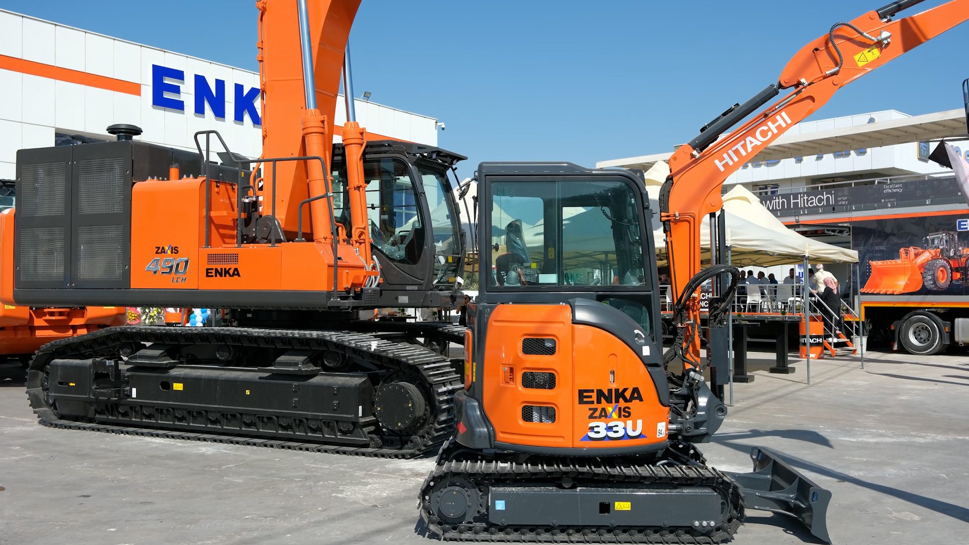 Two orange Hitachi excavators (ZAXIS 490 and 33U) from Enka on display.