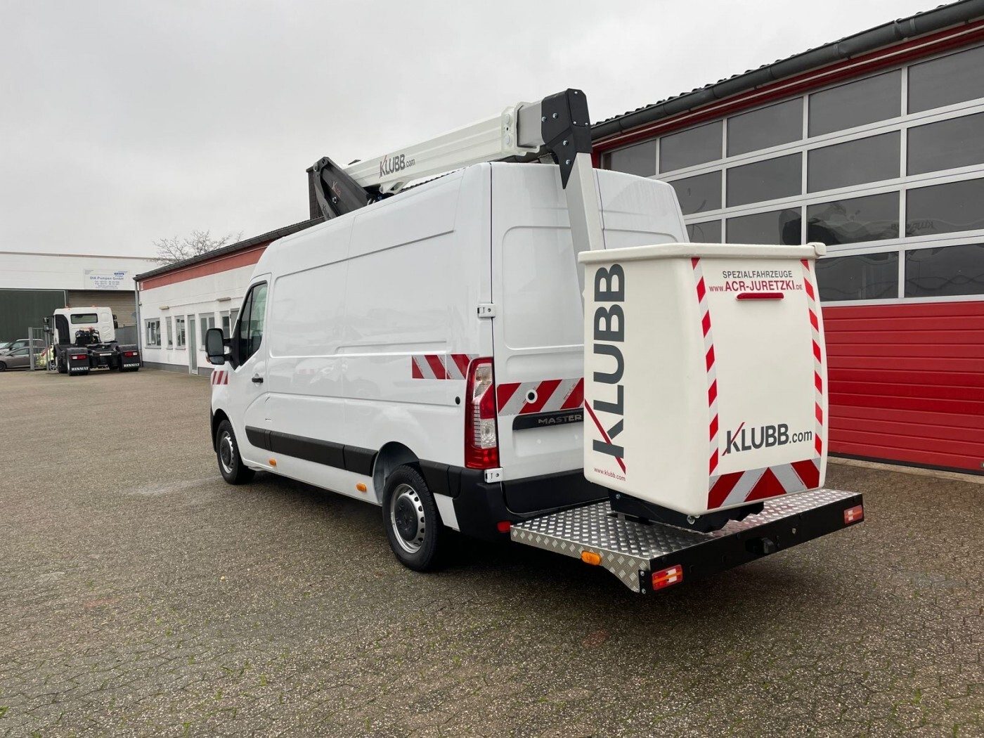 White van with KLUBB aerial lift.