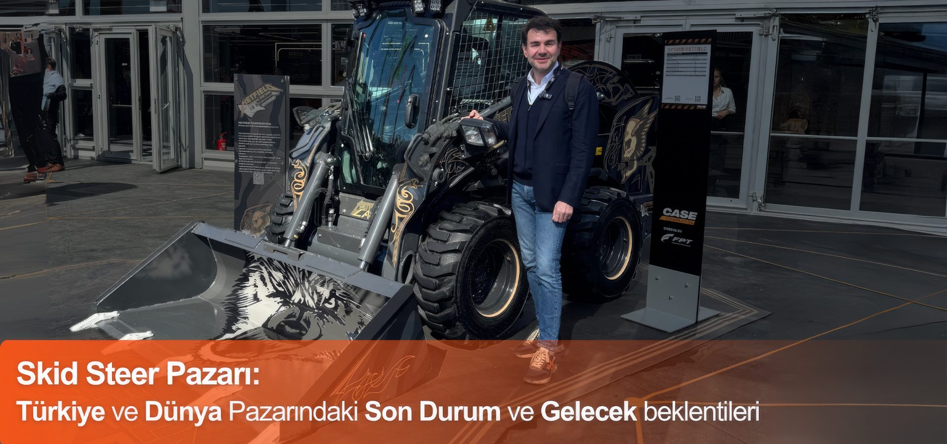 Man next to a black CASE skid steer loader with wolf graphics and text about "Skid Steer Market."