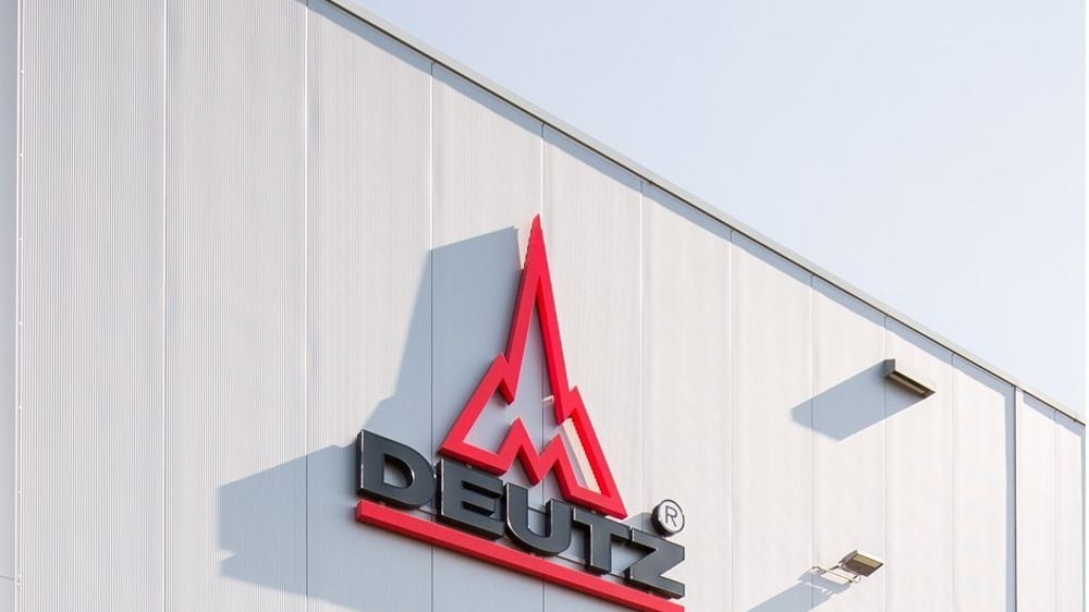 Red and black DEUTZ logo on a white building facade.