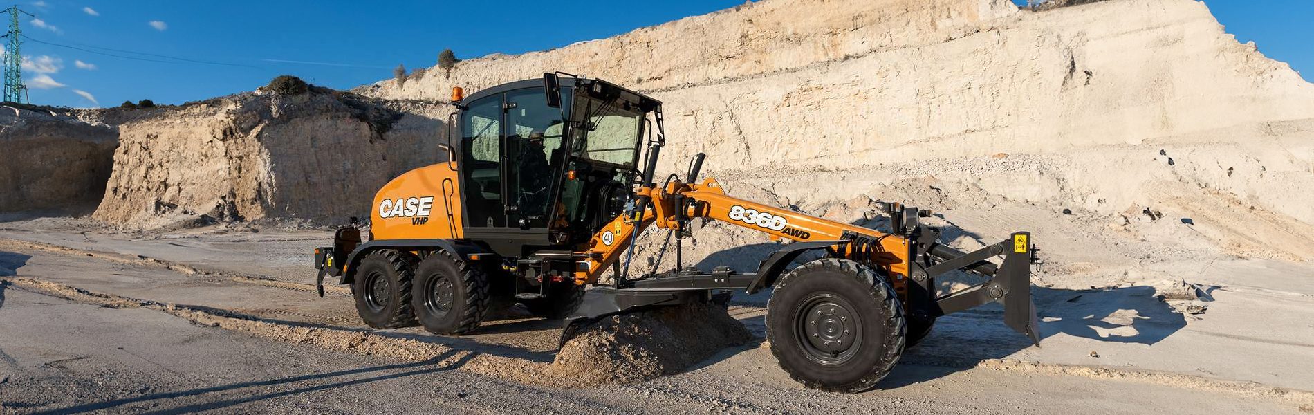 Automotive tire, Motor vehicle, Wheel, Tread, Sky, Asphalt, Bulldozer, Rolling