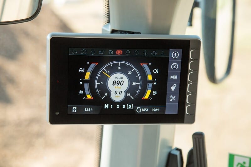 In-cab digital display showing 890 RPM, 0.0 MPH, gear N, 32.5 hours, and other vehicle metrics.