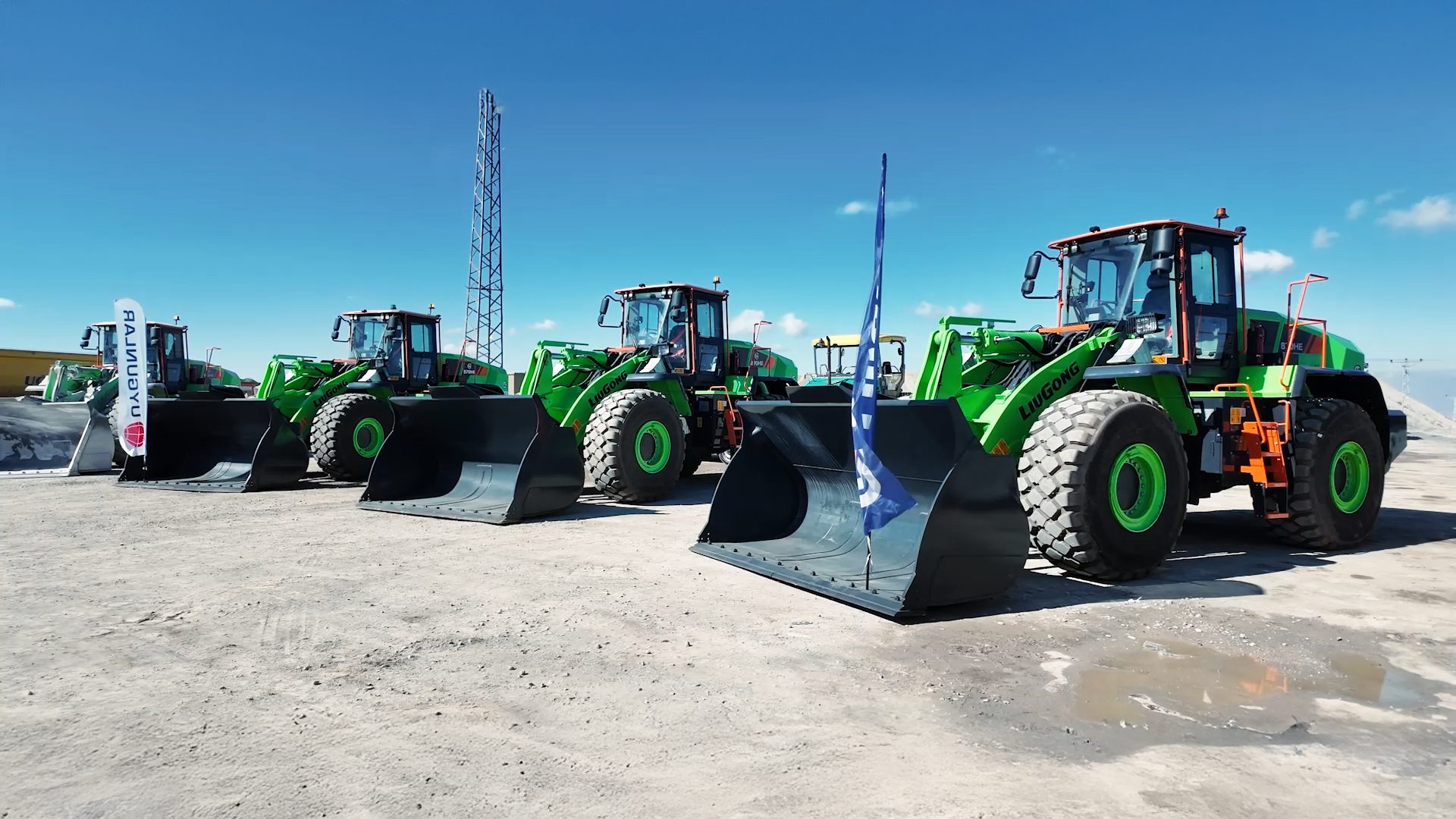 Green LiuGong wheel loaders with large buckets outdoors.