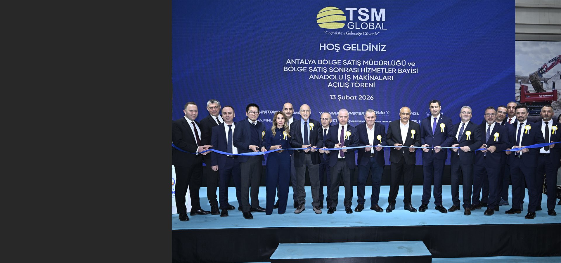 Men in suits cutting a blue ribbon at the TSM Global regional sales and service opening ceremony.