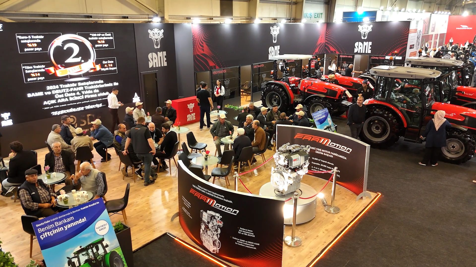 SAME/Deutz-Fahr tractor exhibit: red tractors, visitors, market share screen, and engine display.