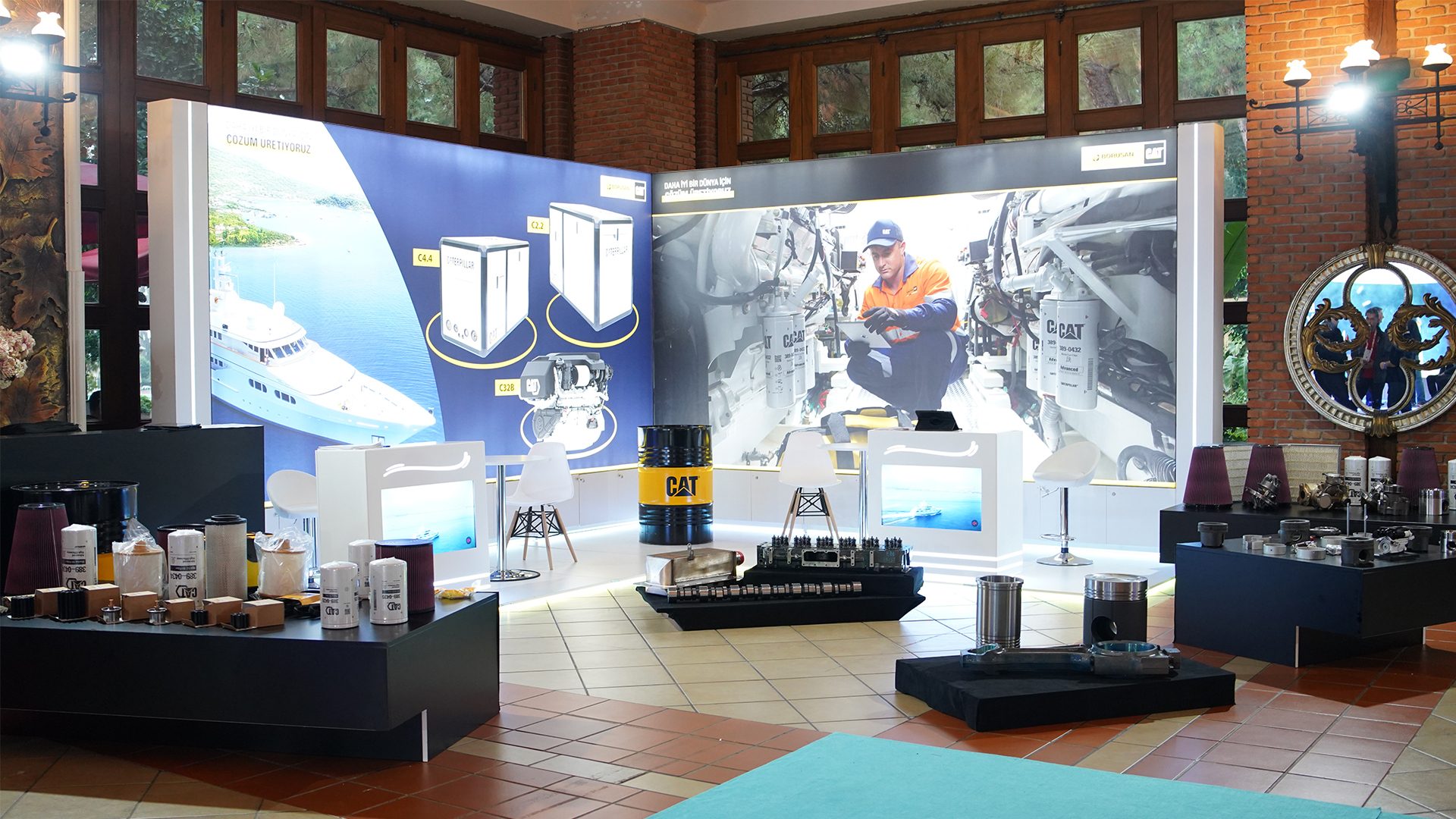 Caterpillar industrial exhibit with marine engines, filters, and parts displays.
