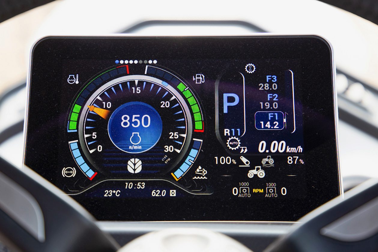 Digital dashboard of a modern tractor, showing engine RPM, current gear, speed, and other operational data.