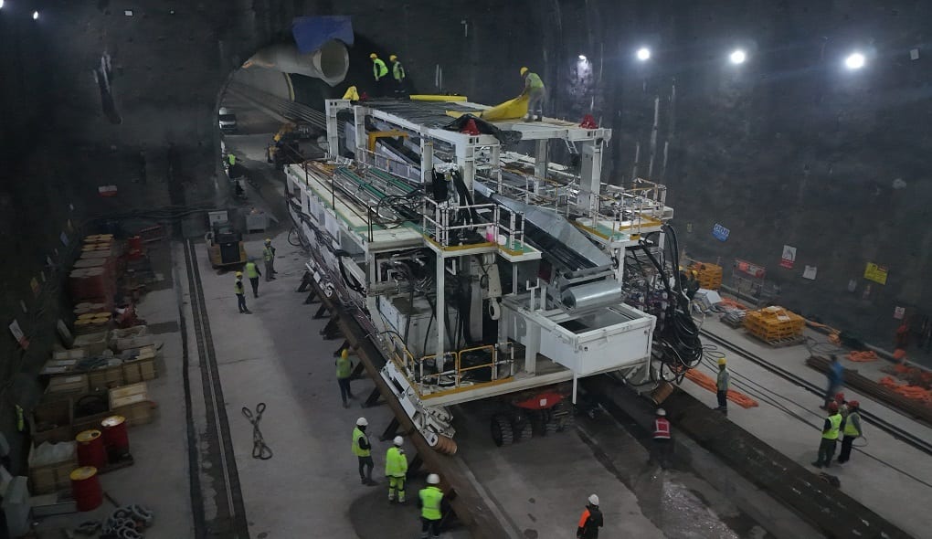 TBM support system and workers inside a tunnel.