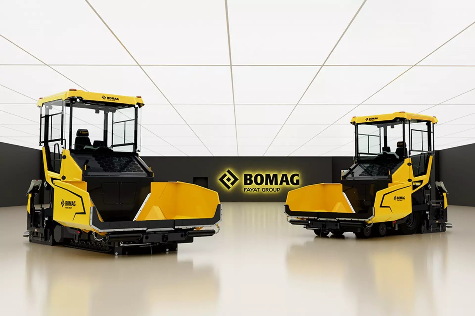 Two yellow Bomag asphalt pavers in a modern studio setting.