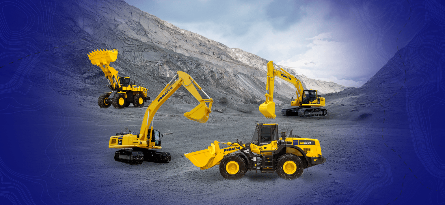 A quartet of yellow Komatsu heavy machinery, including wheel loaders and excavators, in a rugged quarry.