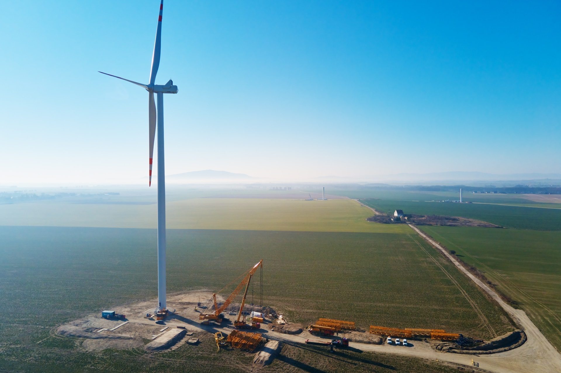 Land lot, Wind farm, Natural landscape, Sky, Windmill, Daytime, Ecoregion, Water, Cloud, Sunlight