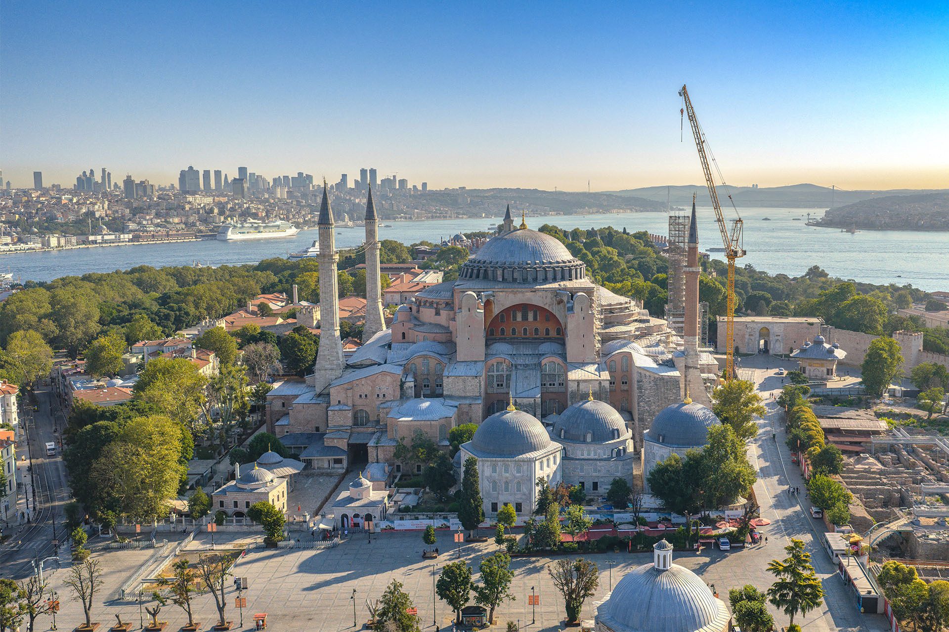 Aerial view of Istanbul's Hagia Sophia, Bosphorus, cityscape, and a construction crane.