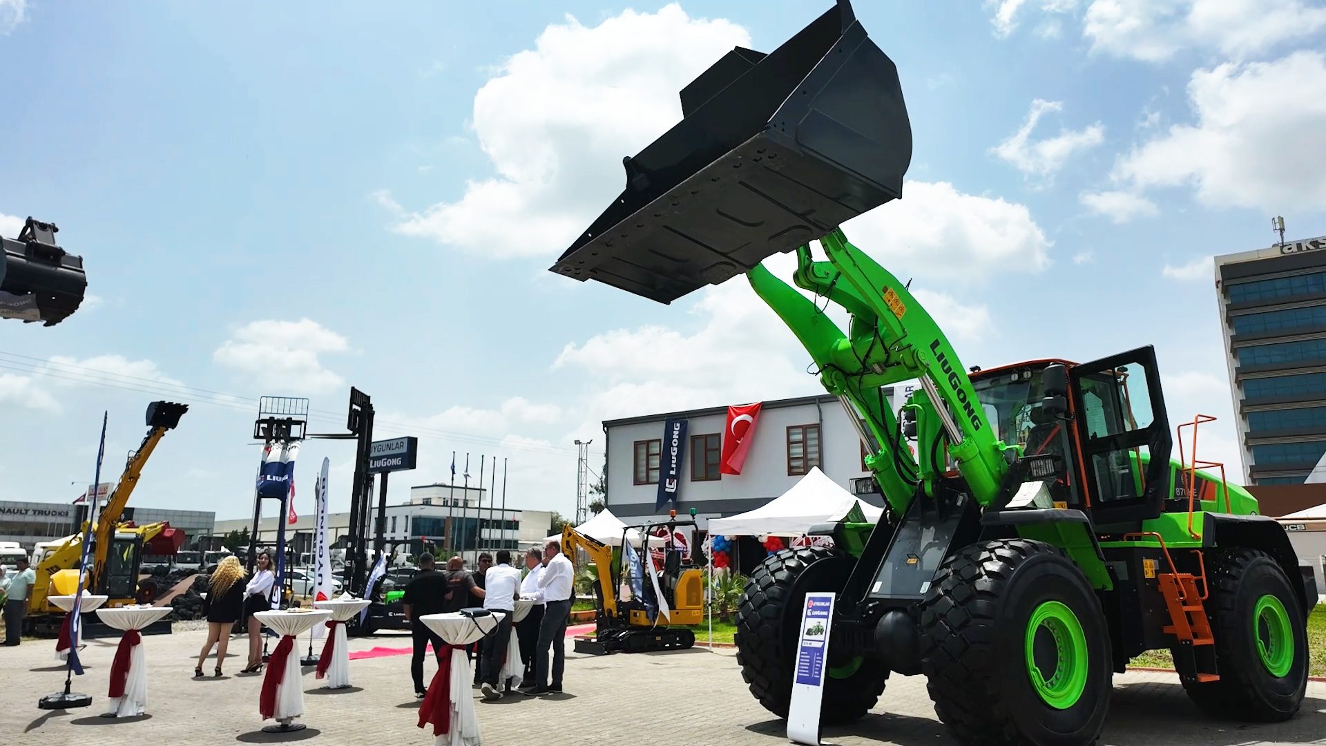 Large green LiuGong wheel loader displayed at an outdoor equipment exhibition.