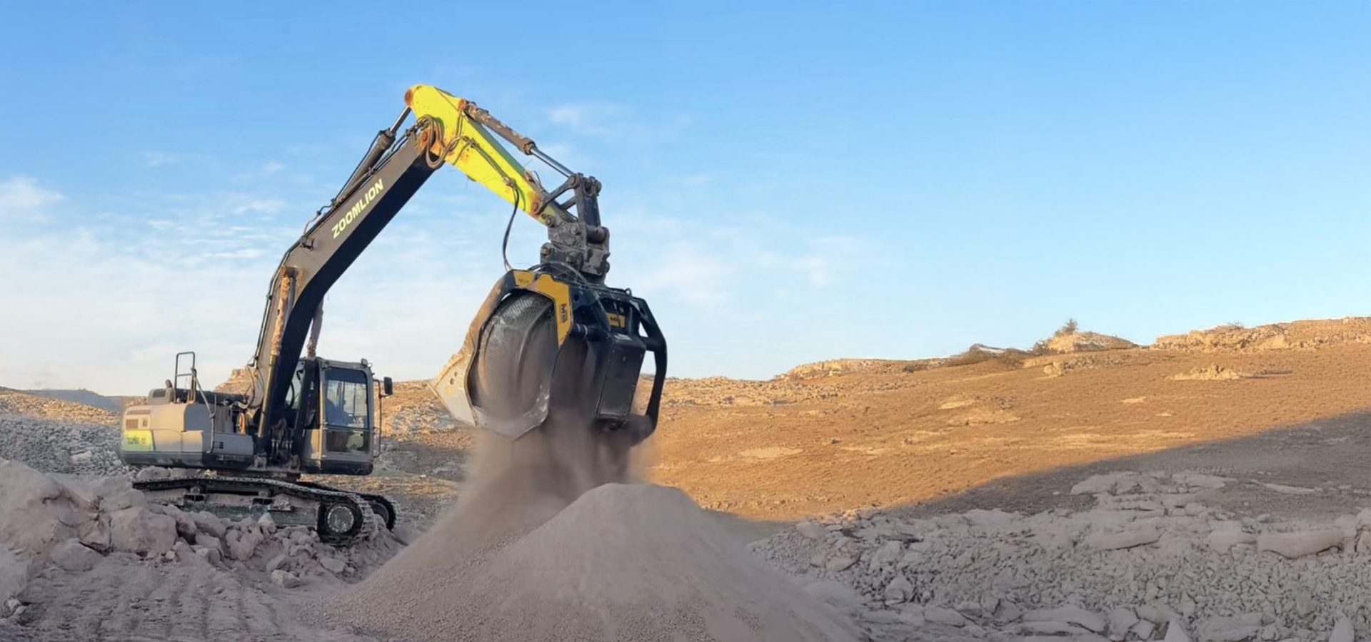 ZOOMLION excavator with a grab bucket releasing material into a pile in a dusty quarry.