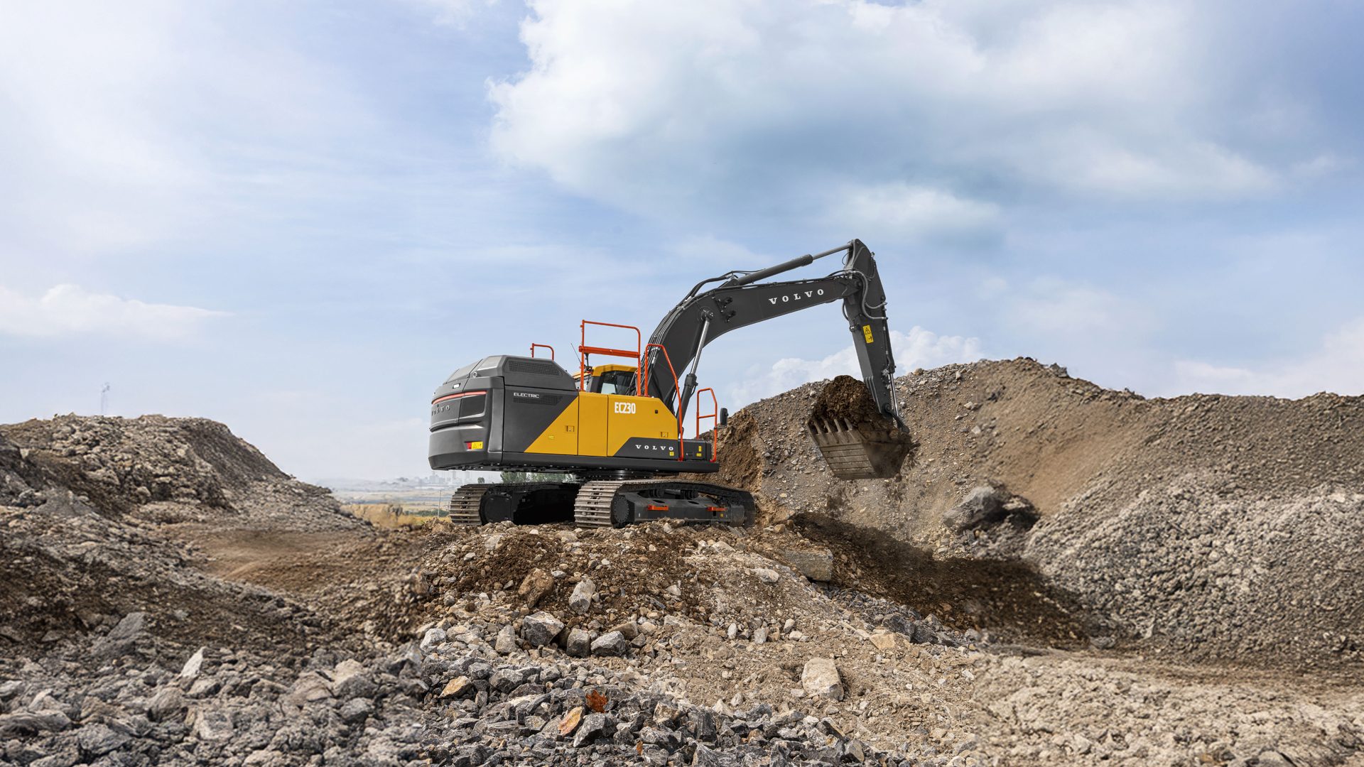 Volvo EC230 Electric excavator digs soil in a quarry, showcasing sustainable heavy machinery at work.