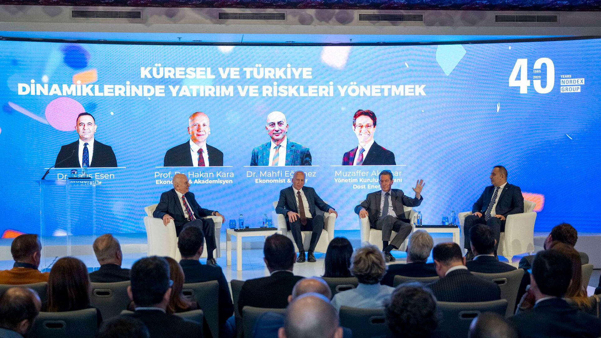 Panel discussion on "Global & Turkey Investment and Risks" with speakers, screen, and audience.