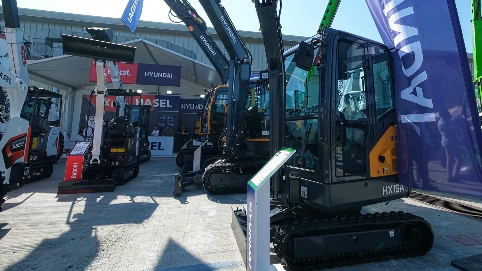 Hyundai excavators and Bobcat equipment displayed at an outdoor exhibition.