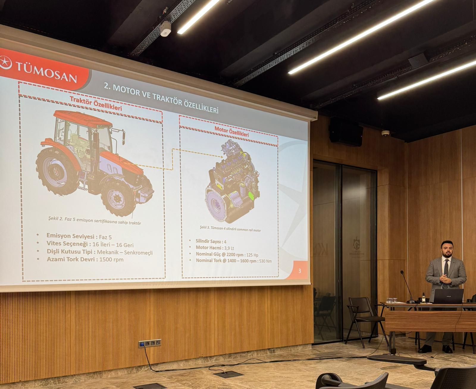 Presenter with TÜMOSAN tractor and engine specifications on a projector screen.