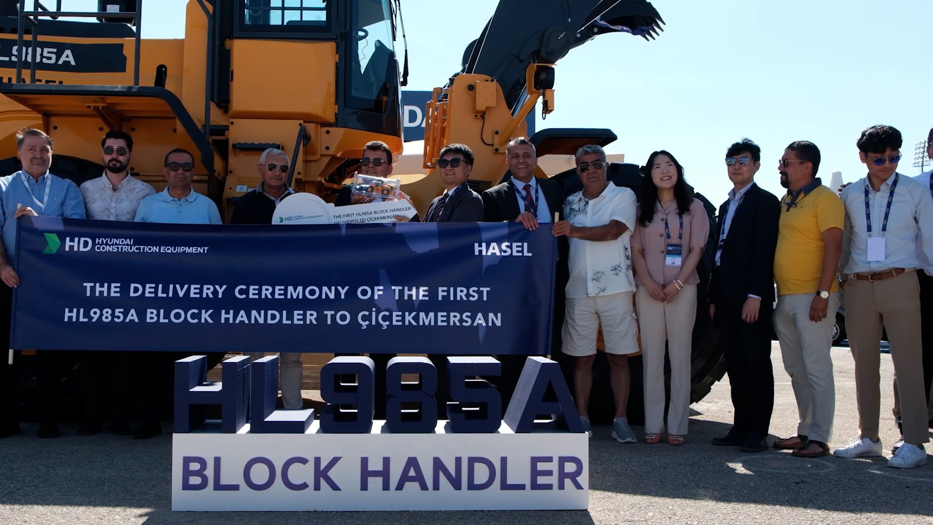 Group photo at the delivery ceremony of a Hyundai HL985A Block Handler.