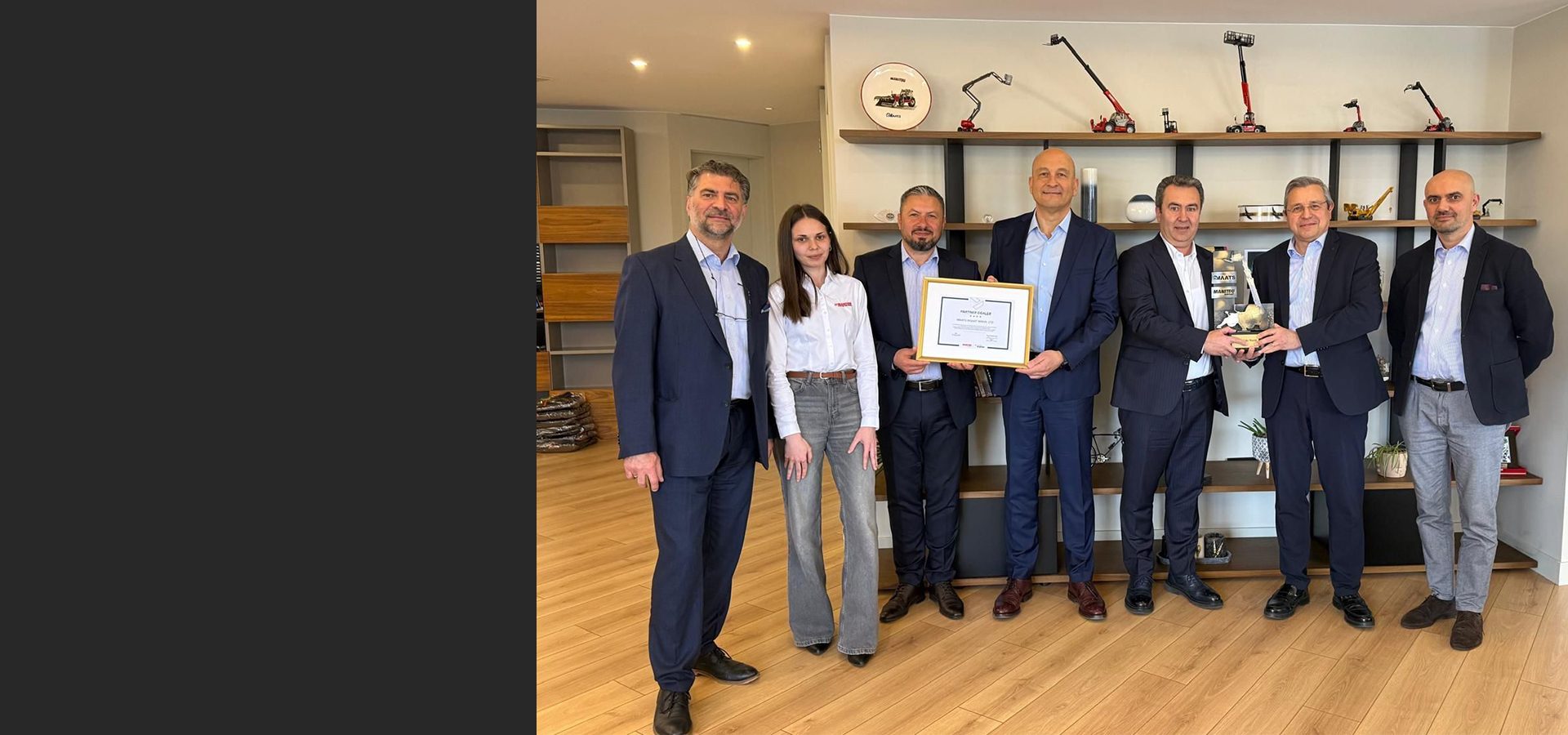 Seven business people, including one woman, receive certificates and awards in a modern office.