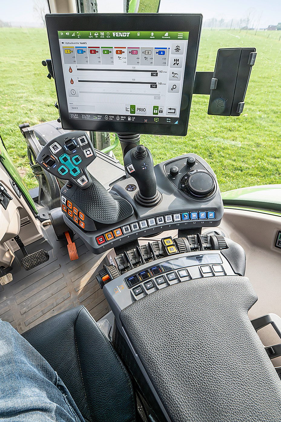 Fendt tractor interior with a large digital display, joystick, and control console.