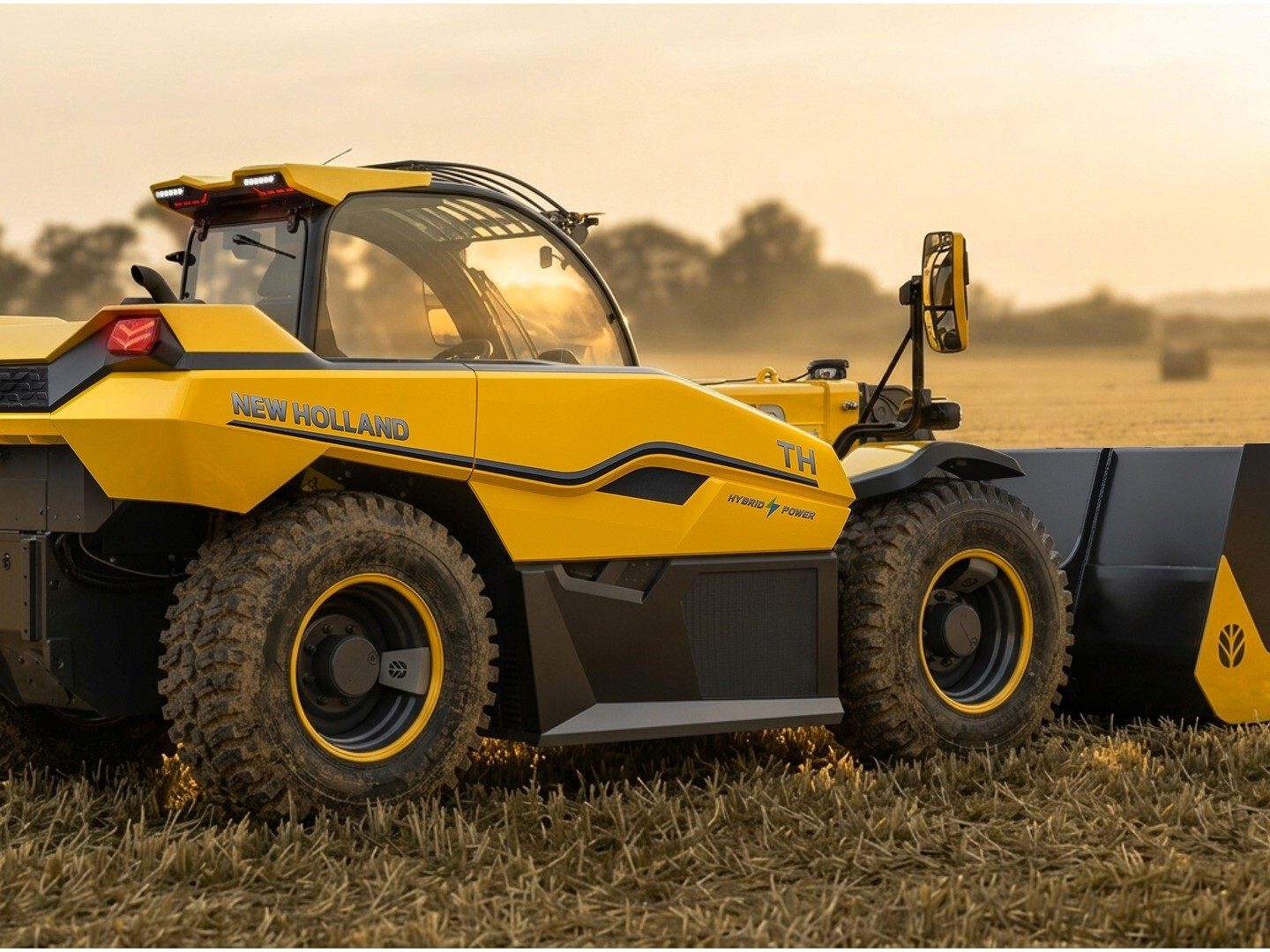 Yellow New Holland TH telehandler with "HYBRID POWER" text, parked in a field at sunset.