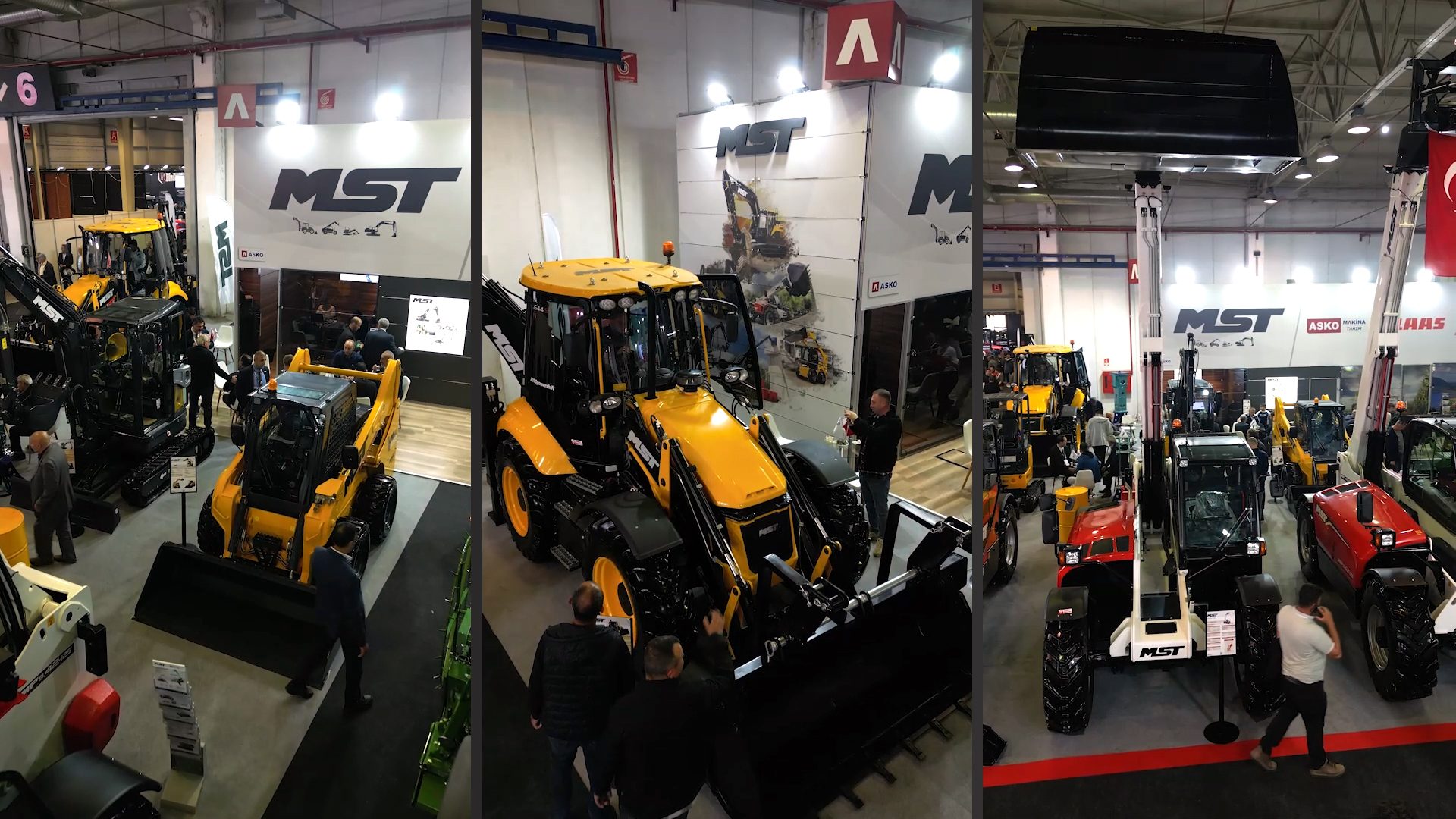 Indoor exhibition of yellow and black MST heavy construction machinery with attendees.
