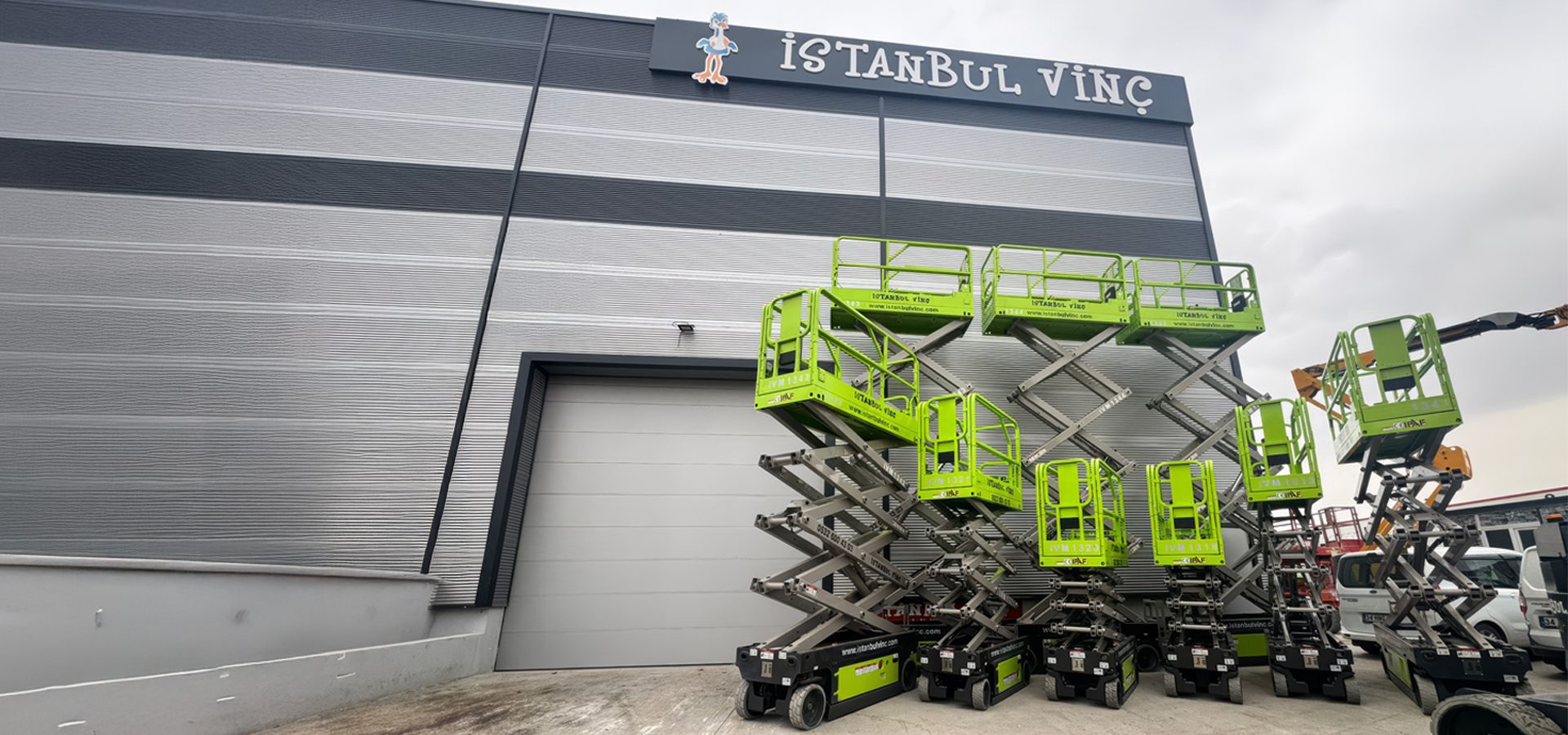 Istanbul Vinc building with bright green scissor lifts parked outside.