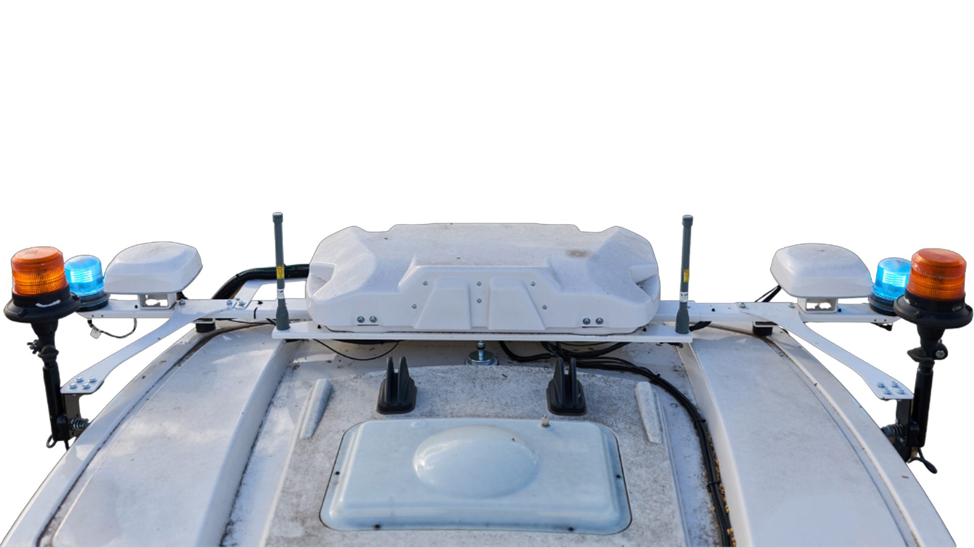 Vehicle roof with orange and blue beacons, antennas, and sensor housing.