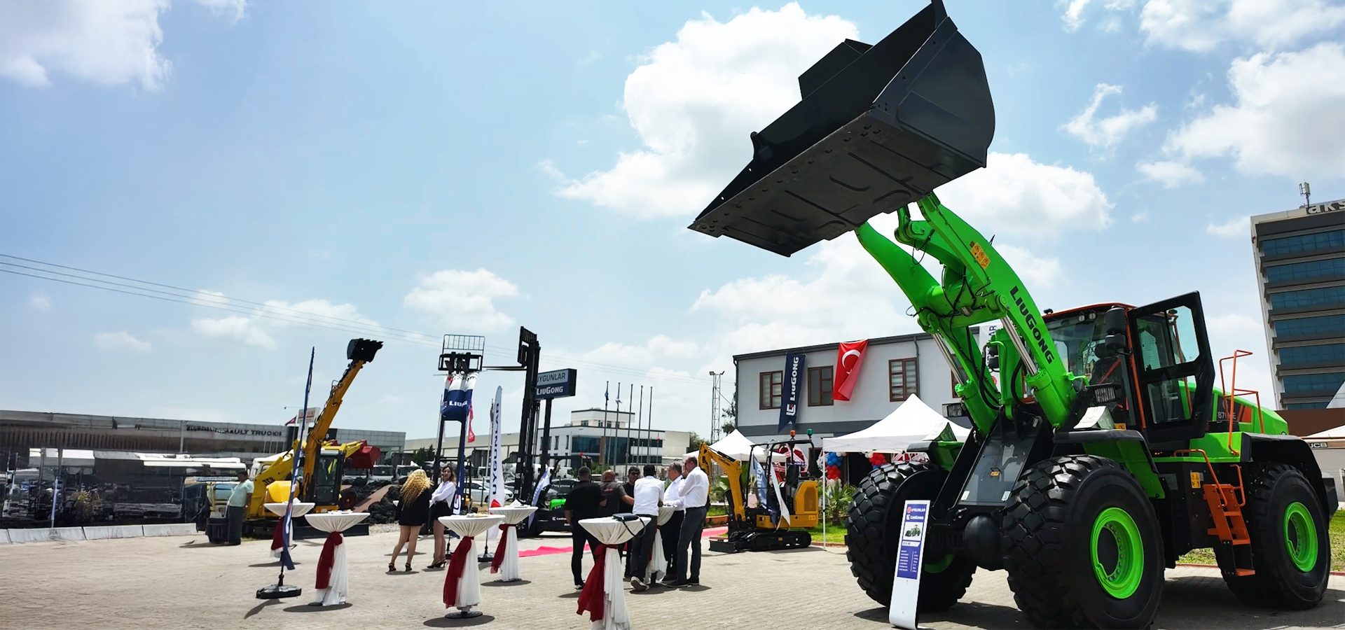 Outdoor heavy equipment exhibition featuring a large green wheel loader.