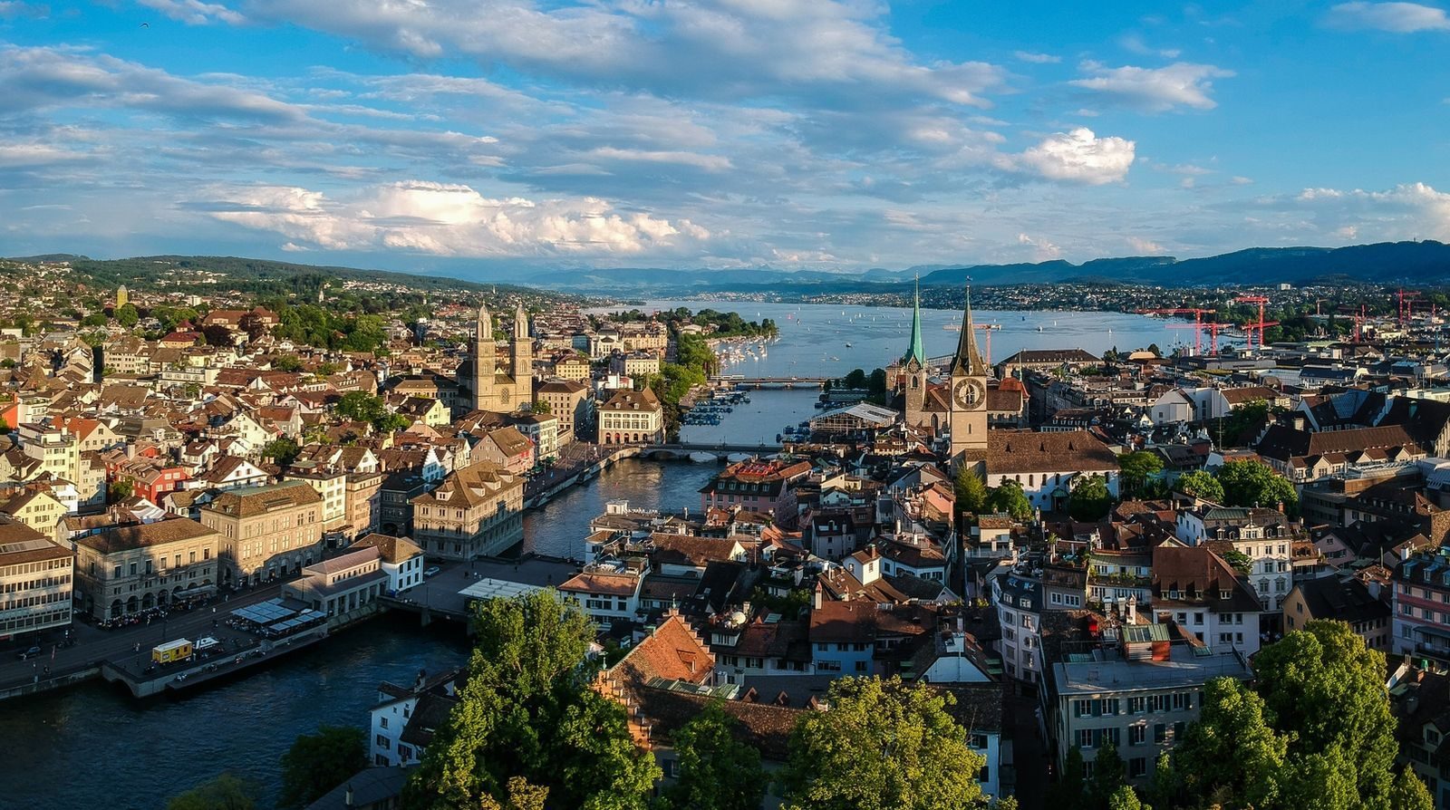 Aerial view of Zurich, Switzerland, with the Limmat River, Lake Zurich, and historic church spires.