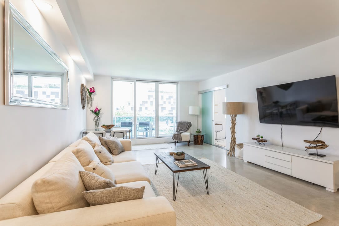 Picture frame, Living room, Couch, Property, Furniture, Plant, Table, Window, Houseplant, Lighting