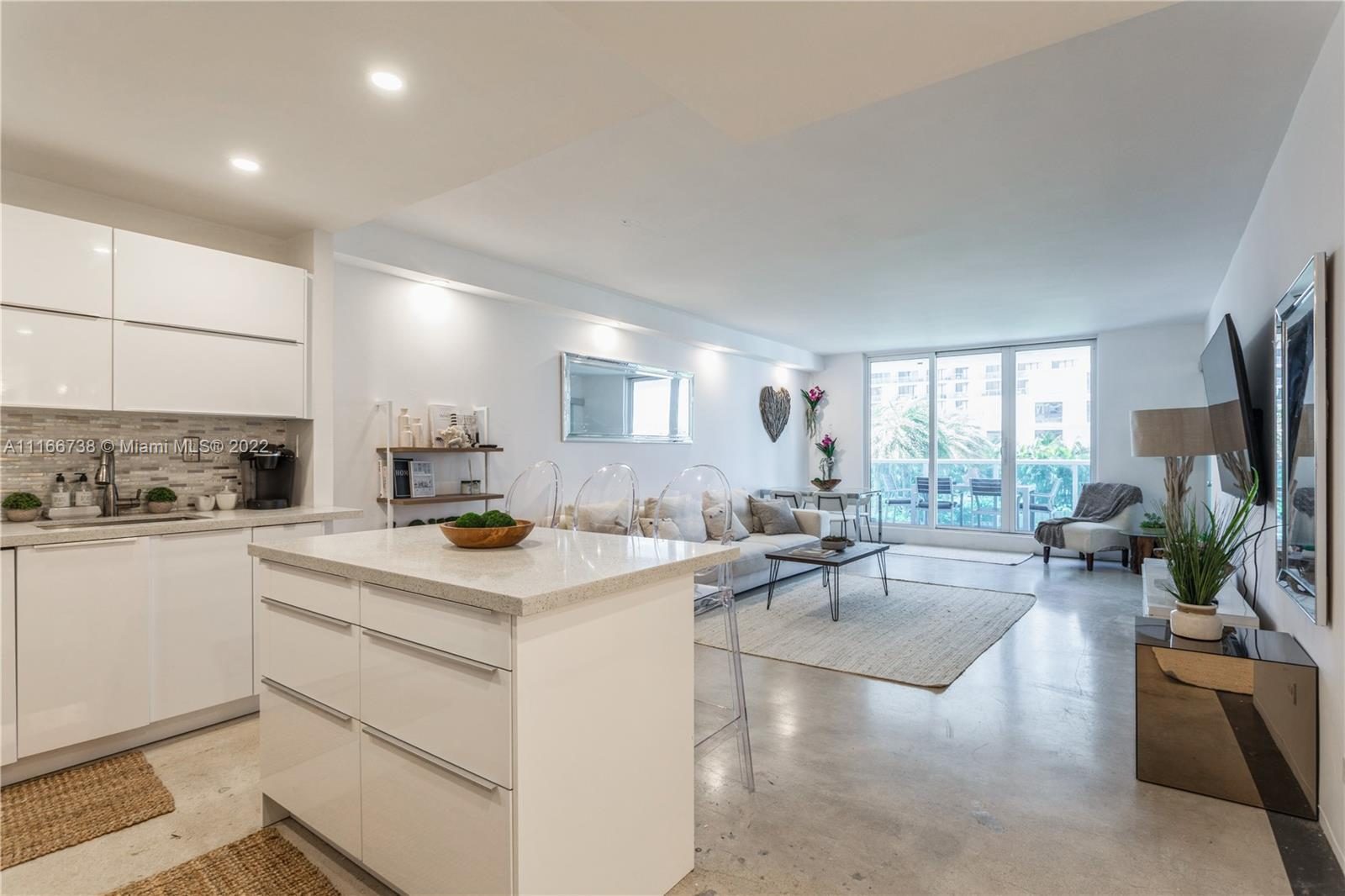 Living room, Plant, Furniture, Countertop, Houseplant, Cabinetry, Table, Couch, Flooring, Kitchen