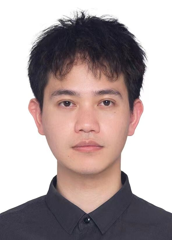 Young man with messy dark hair, black shirt, neutral expression.