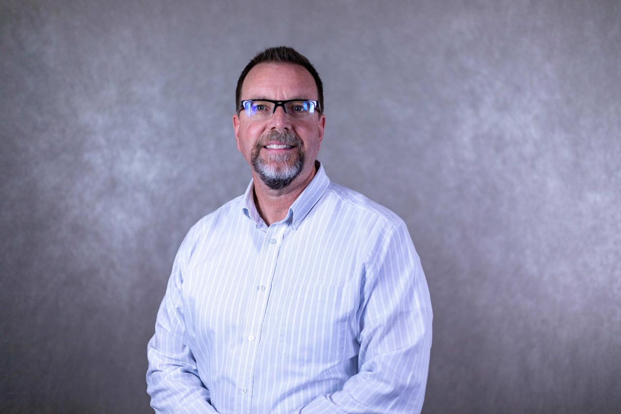 Dress shirt, Flash photography, Forehead, Glasses, Chin, Smile, Arm, Mouth, Beard, Jaw