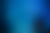 Two children watch sharks, rays, and fish swim in a vast, blue aquarium tank.