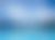 Vibrant turquoise water, snow-capped mountains, and glaciers under a blue sky with clouds.