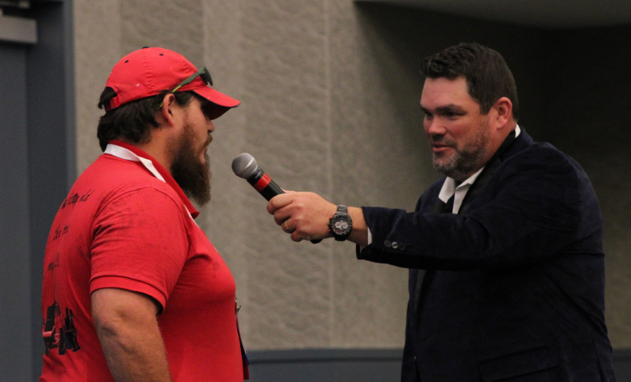 Public address system, Audio equipment, Baseball cap, Microphone, Watch, Arm, Gesture