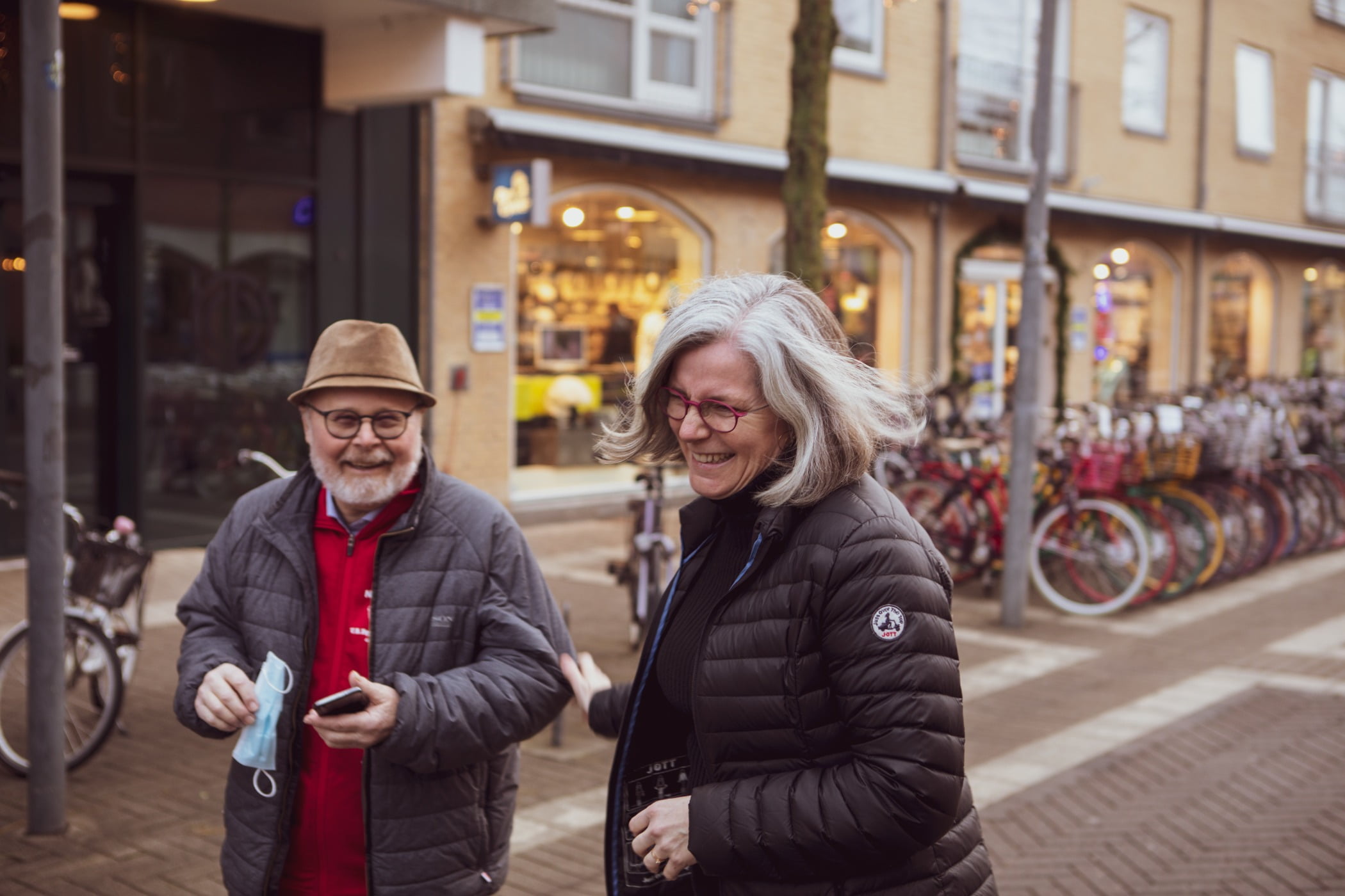 Bicycle wheel, Street fashion, Road surface, Clothing, Tire, Outerwear, Hat, Jacket