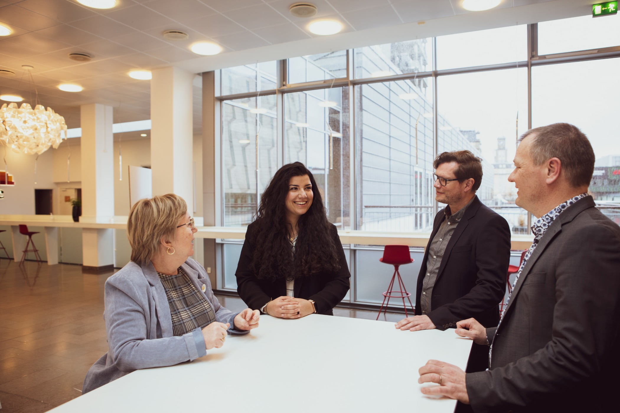 Interior design, Smile, Table, Outerwear, Coat, Chair, Suit