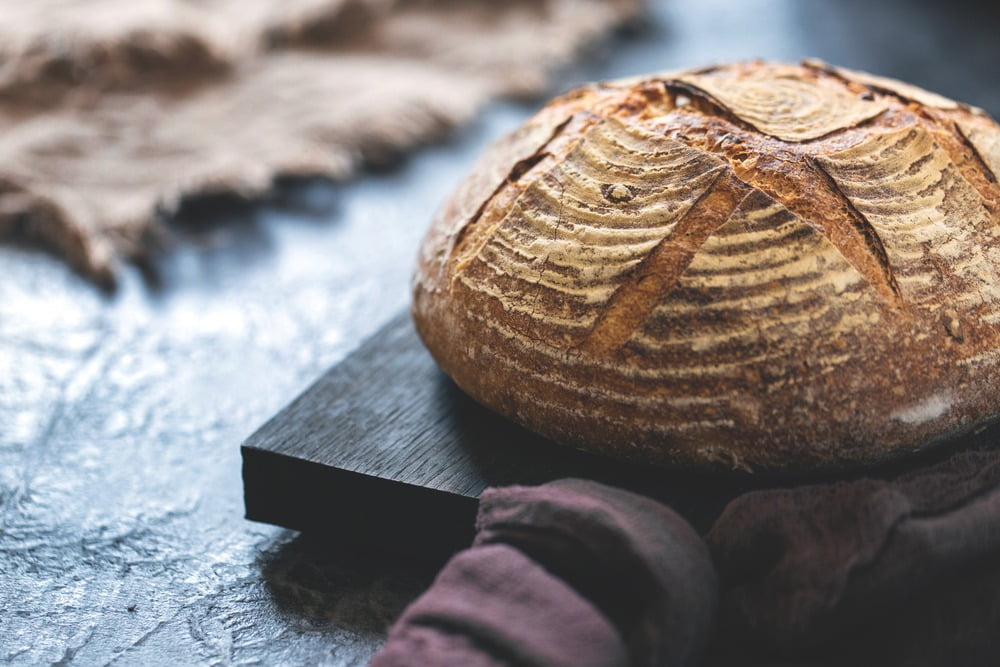Bread, Artisan, Bakery, Wood, Tableware, Loaf, Baked good, Texture