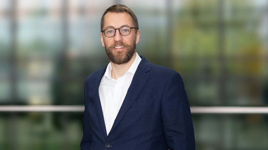 Glasses, Dress shirt, Forehead, Blazer, Smile, Beard, Coat, Sleeve, Gesture, Collar