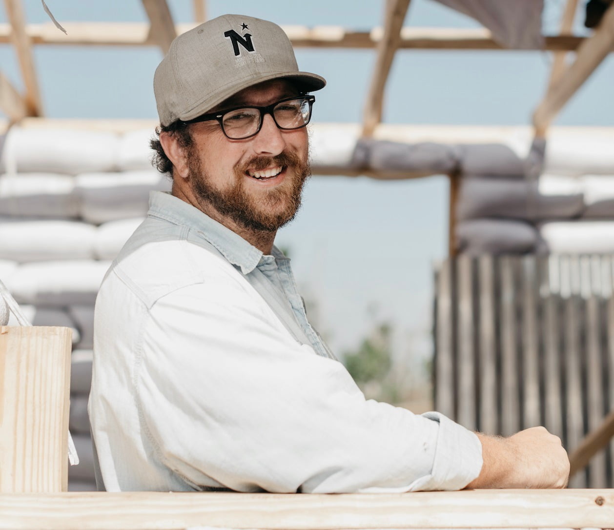 Vision care, Baseball cap, Glasses, Smile, Beard, Human, Sleeve, Headgear, Eyewear