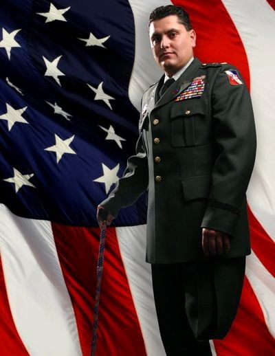 Flag of the united states, Military person, Human body, Government agency, Face, Sleeve, Coat, Gesture, Collar